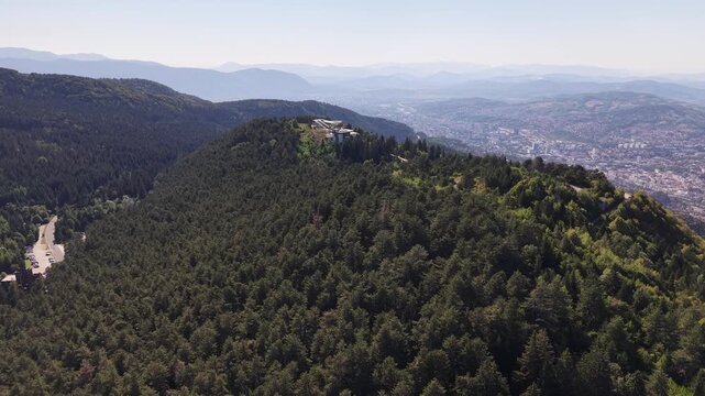 Aerial Flyover of Trebevic Forest Towards Mountain Hotel with Sarajevo Valley View