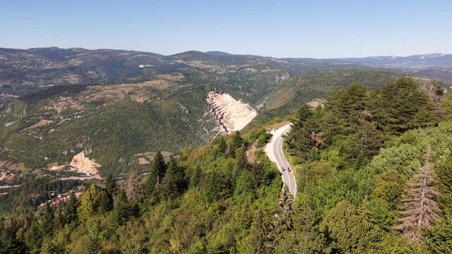 Aerial Flyover of Winding Path on Trebevic Mountain Revealing Distant Quarry