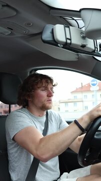 Vertical screen drowsy driver briefly falls asleep behind the wheel then suddenly wakes and brakes hard to avoid danger showing serious accident risk caused by microsleep