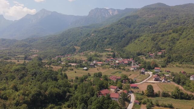 Aerial Flyover of Bijela Village in Valley below Prenj Mountain Peaks