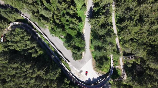 Top Down Aerial View of Car Turning Near Olympic Bobsleigh Track on Trebevic Mountain