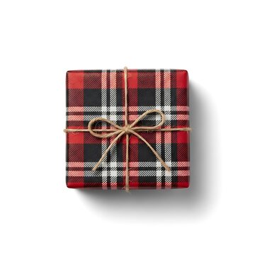 Gift wrapped in plaid pattern sits on white background with light and shadow showing its shape