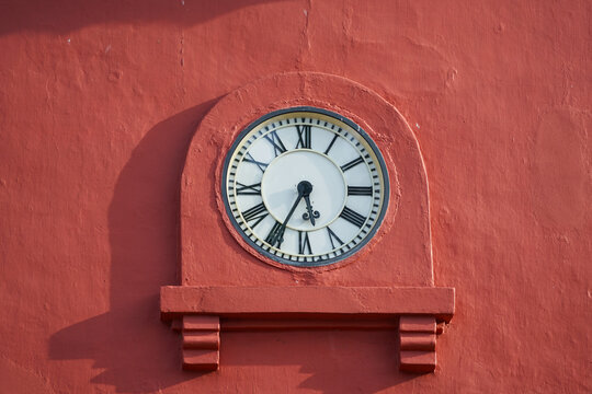 White clock face on red wall, Malaka Clock Tower, Malaysia