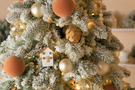 Christmas tree decorated with ornaments and lights in a warm indoor setting