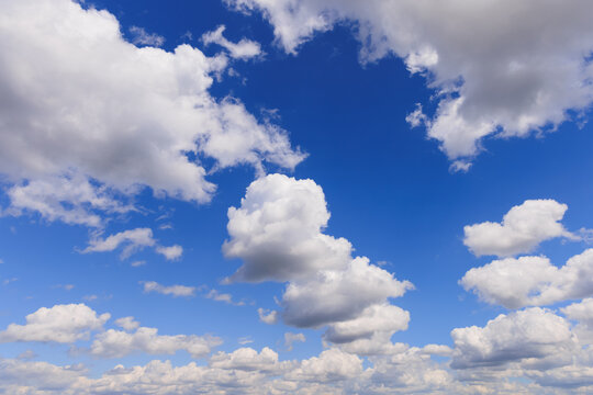 Clouds in a clear blue sky during the daytime providing a view of fluffy shapes floating above