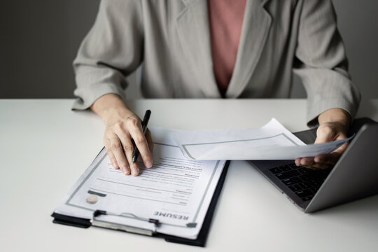 Businesswoman Reviewing Resumes for Recruitment, Hiring Candidates, Analyzing CVs and Applicant Information Before Job Interviews, Human Resources and Recruitment Concept