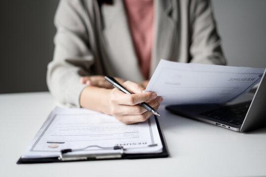 Businesswoman Reviewing Resumes for Recruitment and Hiring Candidates, Analyzing Applicant Information Before Job Interviews in Human Resources and Corporate Office