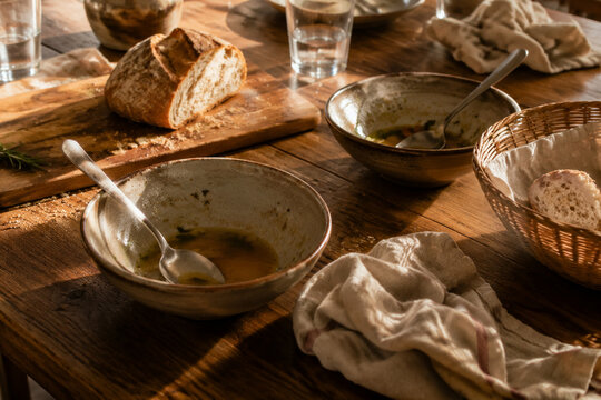 Dinner table with soup bowls and bread remnants, family meal and togetherness concept