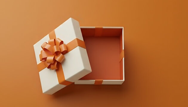 Open empty gift box with ribbon on a brown background