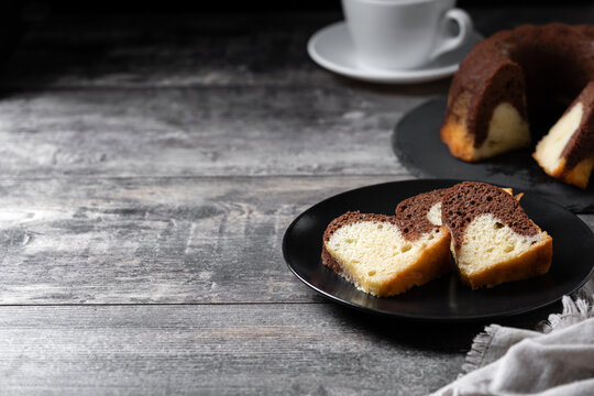 Marble bundt cake on wooden table. Copy space