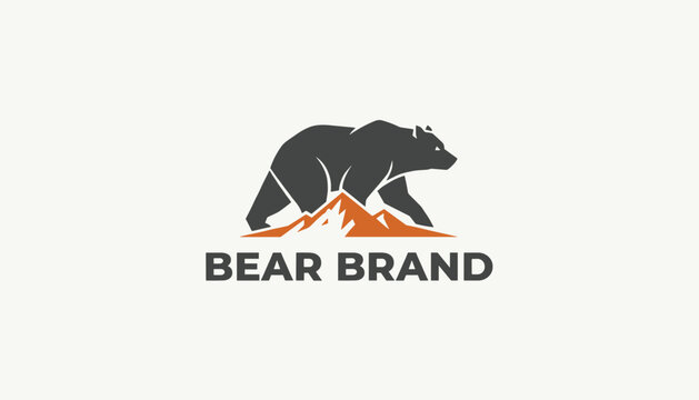 Powerful outdoor logo showing a brown bear silhouette walking across a mountain peak above the words bear brand.