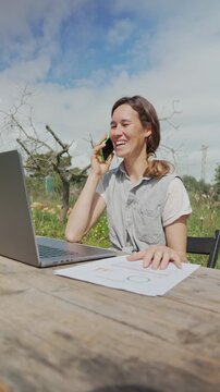 Permaculture farmer talking on phone and working outdoors