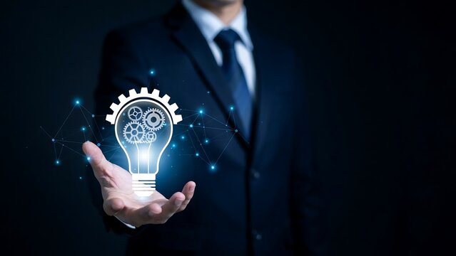 Professional Businessman Holding A Glowing Idea Light Bulb Icon With Integrated Gears Symbolizing Innovation And Creative Business Strategy