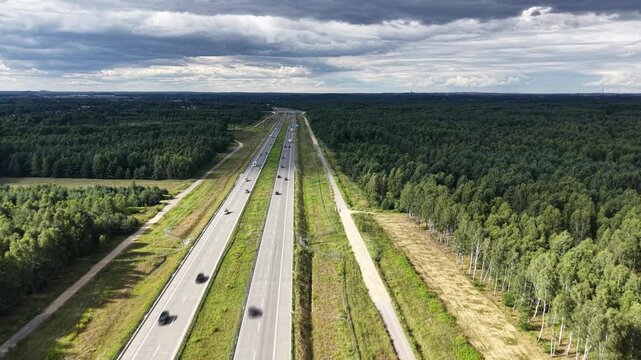 Aerial view of motorway traffic through a forested landscape