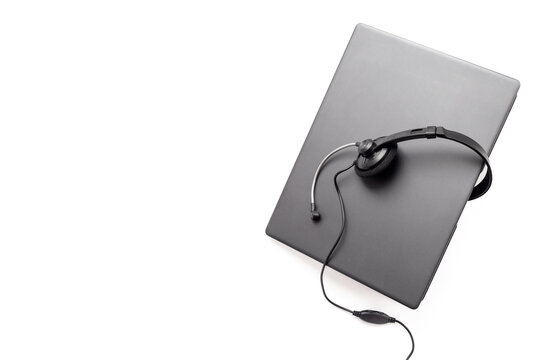 Modern call center desk setup with laptop and headset - online customer service and remote work concept