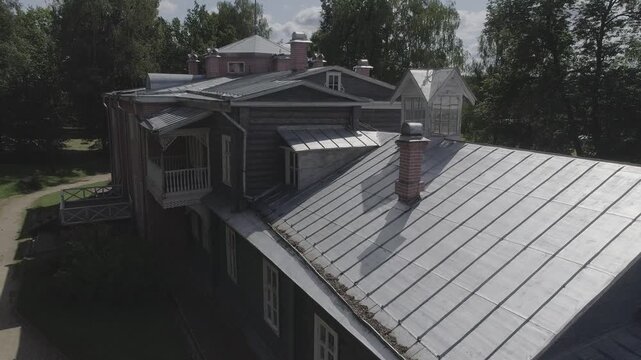 Drone flies along facade of historic building, D-Log