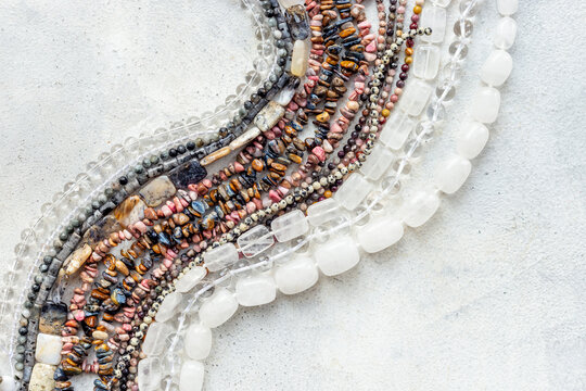 Jewelry and precious concept. Gemstones and beads for necklace, top view, flat lay