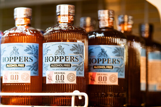 Bottles of Hoppers alcohol free botanical spirit displayed on a hypermarket shelf. Premium zero alcohol beverage concept