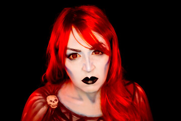 Fototapeta premium Fantasy portrait of a woman with vivid colored hair, blue-toned skin, red eyes and dramatic dark makeup, creating a striking supernatural character on a dark background.