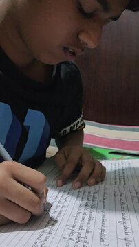 Young Boy Studying at Home with School Book, Child Doing Homework at Desk, Education and Learning Concept, Student Reading Textbook, Concentration, Childhood Development and Academic Study
