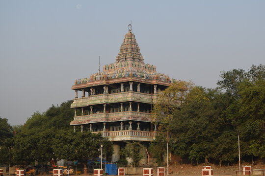 Multi tiered Shankar Viman Mandapam temple structure surrounded by green trees in Prayagraj India