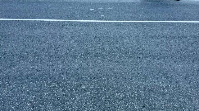 Close Up View of Smooth Asphalt Road Surface with White Painted Line