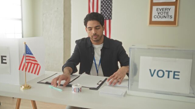 Man placing an i voted sticker on a clear ballot box with his hand at a polling station building with american flag and vote sign; civic duty pride.