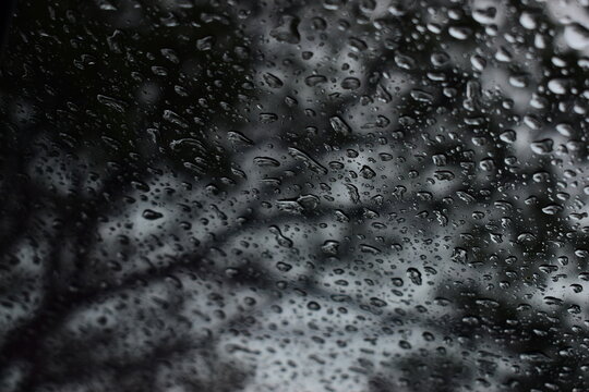 abstract natural texture of raindrop moisture beads on transparent glass window