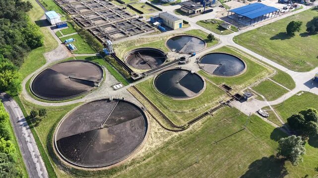 Modern water treatment facility with circular settling tanks from above