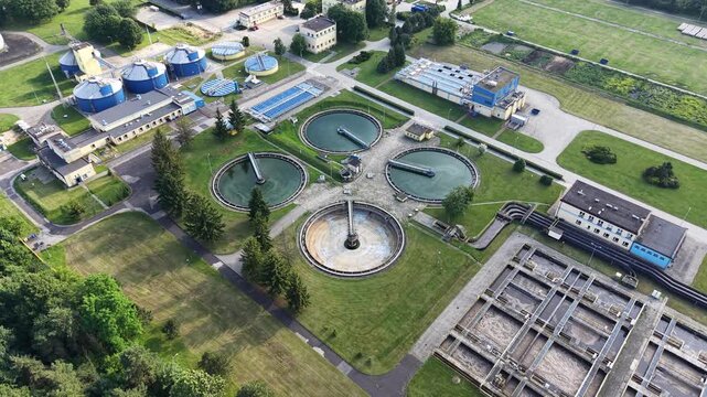 wastewater treatment plant with multiple circular clarifier tanks and processing infrastructure