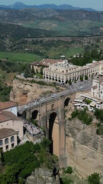 Ronda aerial vertical view - the famous Puente Nuevo Bridge over the El Tajo gorge, a historic town on the edge of a rocky gorge