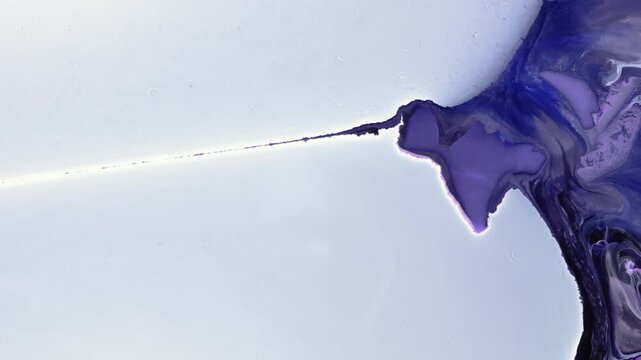 Mixing alcohol inks and epoxy resin in a close-up view in a workspace