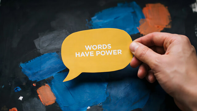 A hand holding a speech bubble cutout with the words have power text