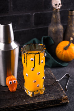 Spooky orange Halloween monster cocktail with eyes