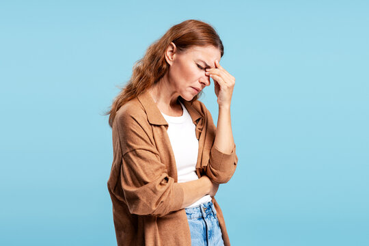 Mature woman experiencing headache pain and stress