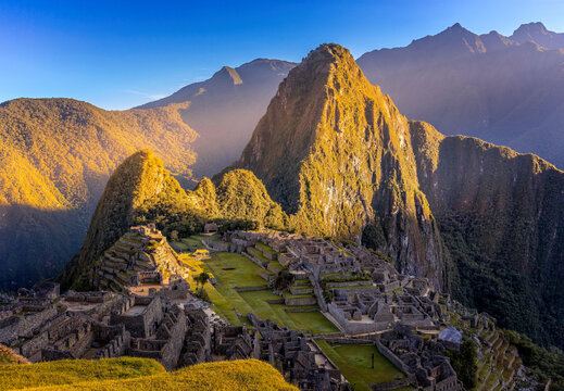 Machu Picchu at Sunrise with First Golden Sunlight Illuminating Huayna Picchu in the Peruvian Andes