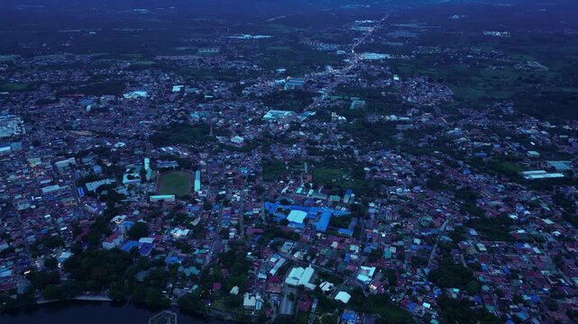 Blue hour footage documenting Sampaloc Lake in San Pablo City, Laguna, Philippines, featuring volcanic lake scenery, lakeside communities, tropical vegetation, and mountain landscapes for tourism.