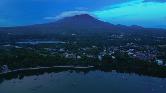 Blue hour aerial frame capturing Sampaloc Lake, Bunot Lake, the urban landscape of San Pablo City, and the distant silhouette of Mount San Cristobal in n San Pablo City, Laguna, Philippines.