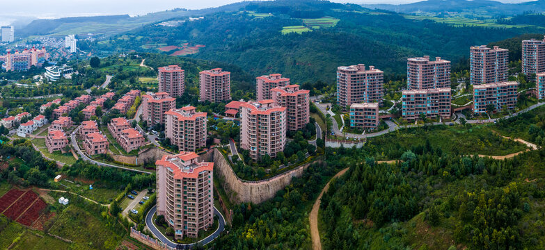 Aerial view of residential community at Fuxian Lake Cambrian resort, Yunnan China, mountain‑side apartment buildingsdefault