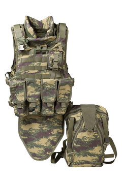Tactical body armor vest with groin protector and backpack isolated on white background. Camouflage military plate carrier set