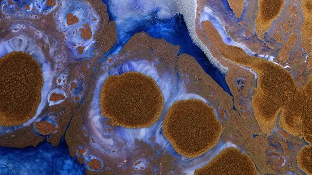 Mixing alcohol inks with epoxy resin in close-up view showing colors