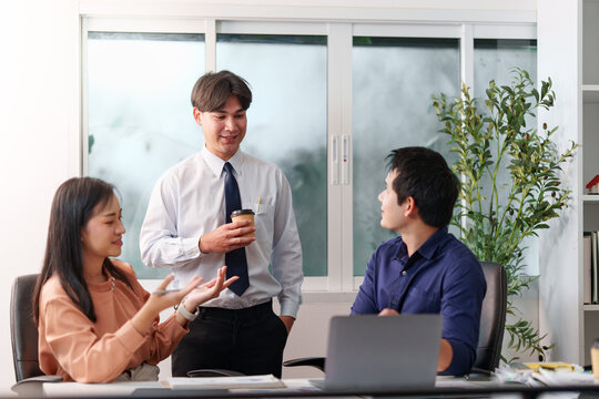 Asian business team discussing artificial intelligence strategy and digital technology in office