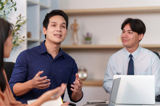 Asian businessman leading discussion in office meeting for digital technology and corporate strategy