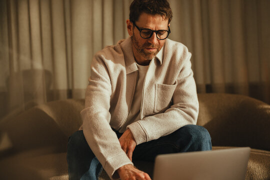 Focused business man works on a laptop in a remote work setup