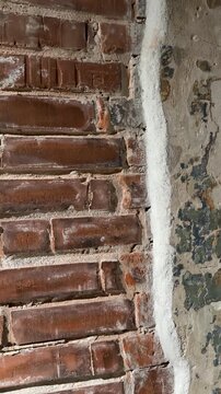 Aged brick and concrete wall texture showing wear, perfect for backgrounds and industrial themes