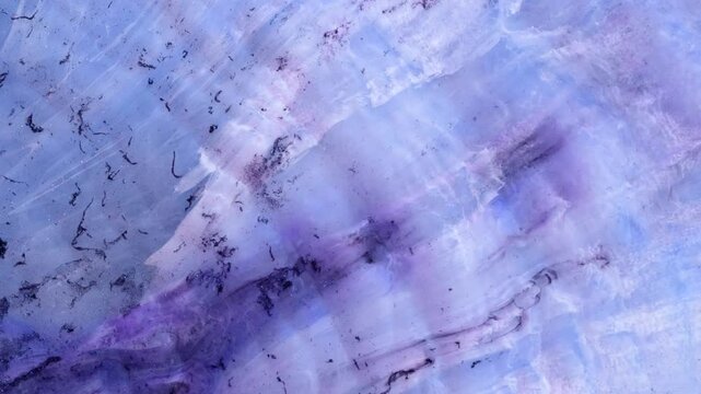 Mixing alcohol inks and epoxy resin in multiple colors on a flat surface