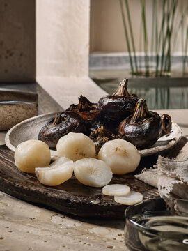 Fresh Water Chestnuts with Whole Dark Corms and Peeled White Flesh