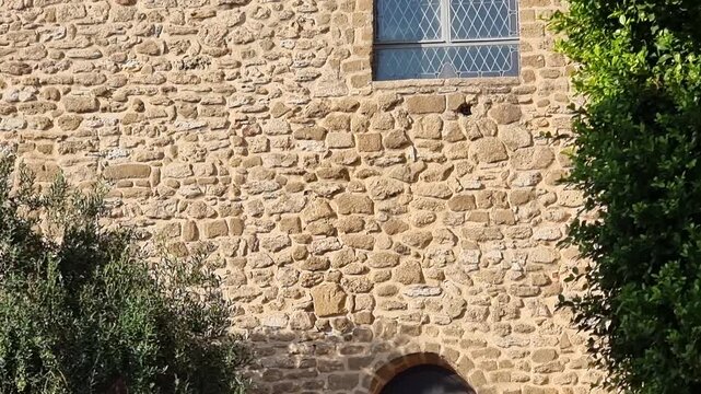Stone facade of the town hall of Rota, located in Castillo de Luna, Rota town, Cadiz province, Andalusia, Spain. Historic castle architecture with battlements and pointed arched window.
