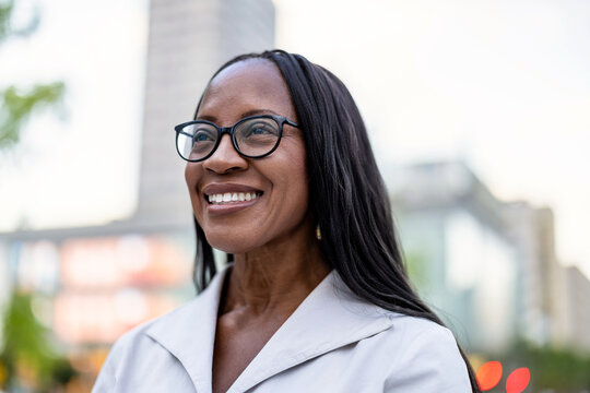 Portrait of a happy businesswoman smiling in the city
