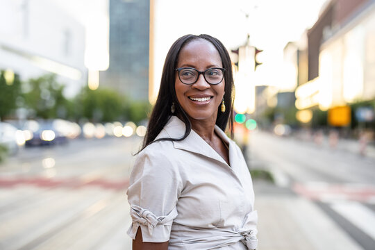 Portrait of a happy businesswoman smiling in the city
